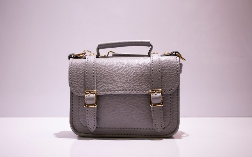 black-leather-handbag-on-white-table-j4dnkxz-3sa